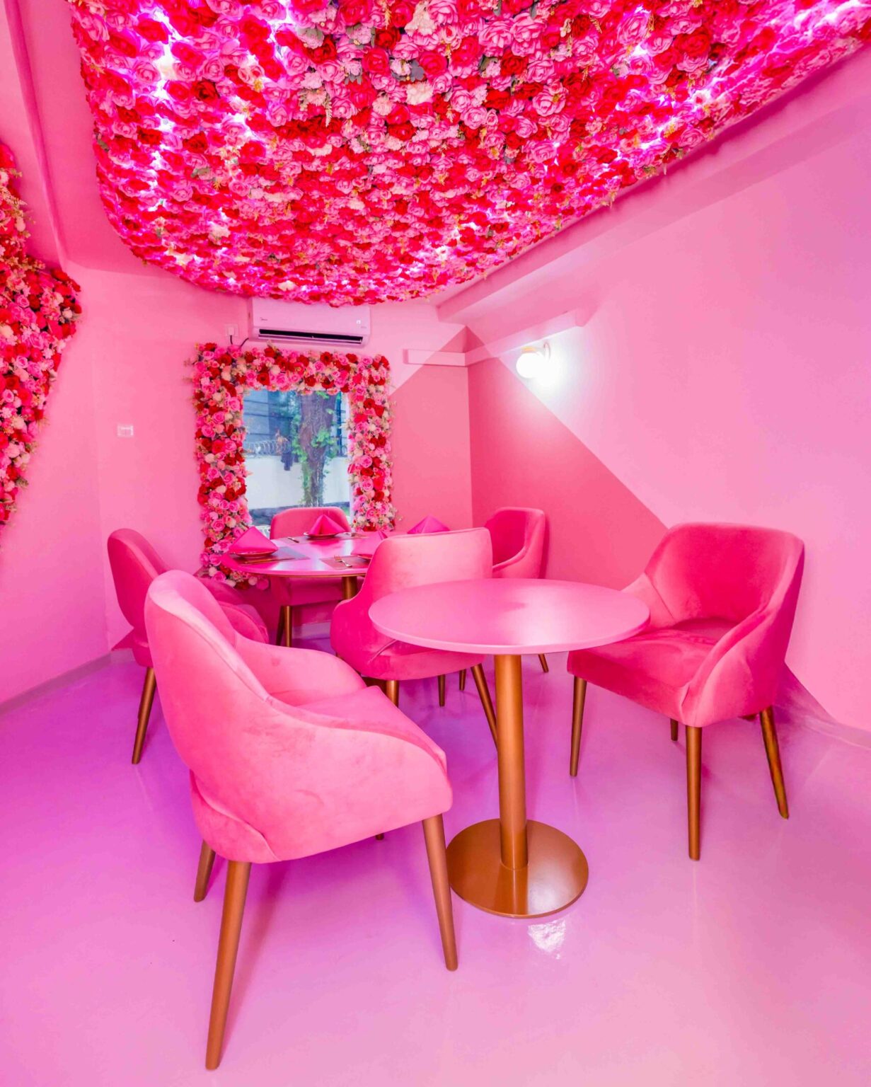 Rose Oud Café hallway adorned with floral accents and golden lighting