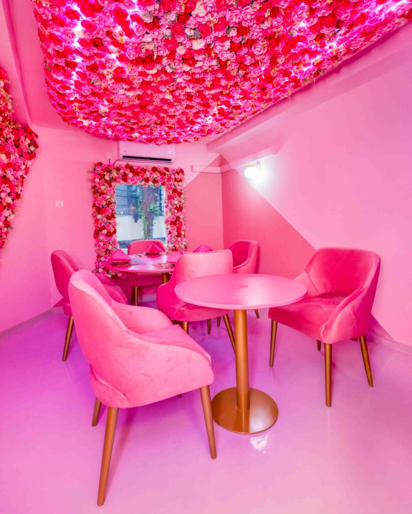 Rose Oud Café hallway adorned with floral accents and golden lighting