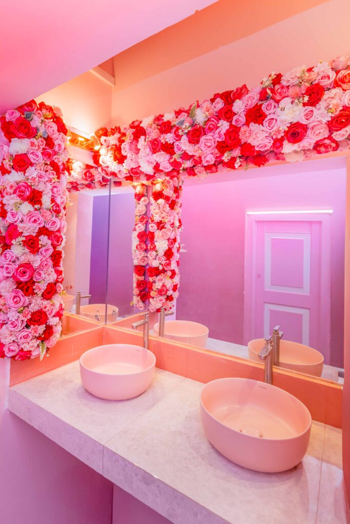 Signature café interior combining roses, wood, and gold accents